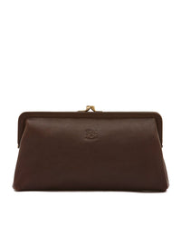 The Manuela Clutch in Caffe by IL BISONTE showcases brass hardware, a subtle embossed logo on the front, and fine Italian craftsmanship, all set against a white background.