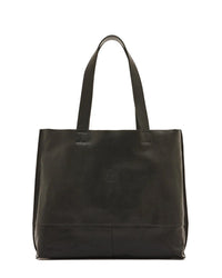 The IL BISONTE Talamone Tote in Nero features brass hardware, vegetable-tanned cowhide, two shoulder straps, and a minimalist design, displayed against a plain white background.