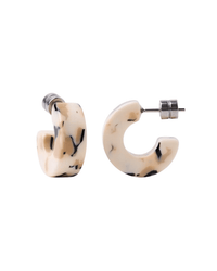 The Machete Muse Hoops in Terrazzo are small, chunky earrings crafted from cream Italian acetate with black marbled patterns and hypoallergenic posts, shown on a white background.