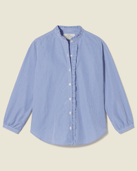 The Helena Shirt in Blue/White Stripe by Trovata Birds of Paradis features vertical stripes, a ruffle collar, long sleeves with ruffled cuffs, and is shown flat against a light background.