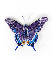 The Trovelore Eastern Black Swallowtail Butterfly Brooch Pin is hand-embroidered in India with sequins and beads in purple, blue, white, and black, featuring intricate detailing and beaded antennae.