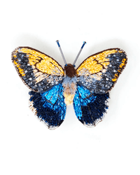 The Trovelore Giant Owl Butterfly Brooch Pin features hand-embroidered yellow, black, blue, and orange patterned wings. Handmade in India, it is displayed against a white background.