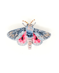 The Trovelore Hubbard's Small Silk Moth Brooch Pin features blue and pink wings, intricate beadwork, and gold accents—an elegant hand-embroidered accessory ideal for brooch enthusiasts. Displayed on a white background.