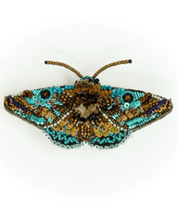The Trovelore Lanipes Moth Brooch Pin is hand-embroidered in India with beads and sequins in turquoise, brown, gold, and black for a lifelike moth-wing effect—a beautiful decorative accessory.