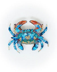 The Trovelore Ornate Blue Crab Brooch Pin features a hand-embroidered design with sequins and beads in blue, orange, and gold tones, displayed on a plain white background.