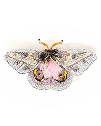 The Pink Eyed Silk Moth Brooch Pin by Trovelore features intricate embroidery in pastel pink, yellow, black, and white threads for realistic wings and body, inspired by the silk moth and displayed on a white background.