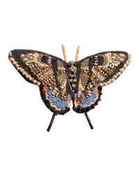 The Swallowtail Butterfly Brooch Pin by Trovelore showcases brown, gold, blue, and orange beading with detailed embroidery, beautifully displayed on a white background.