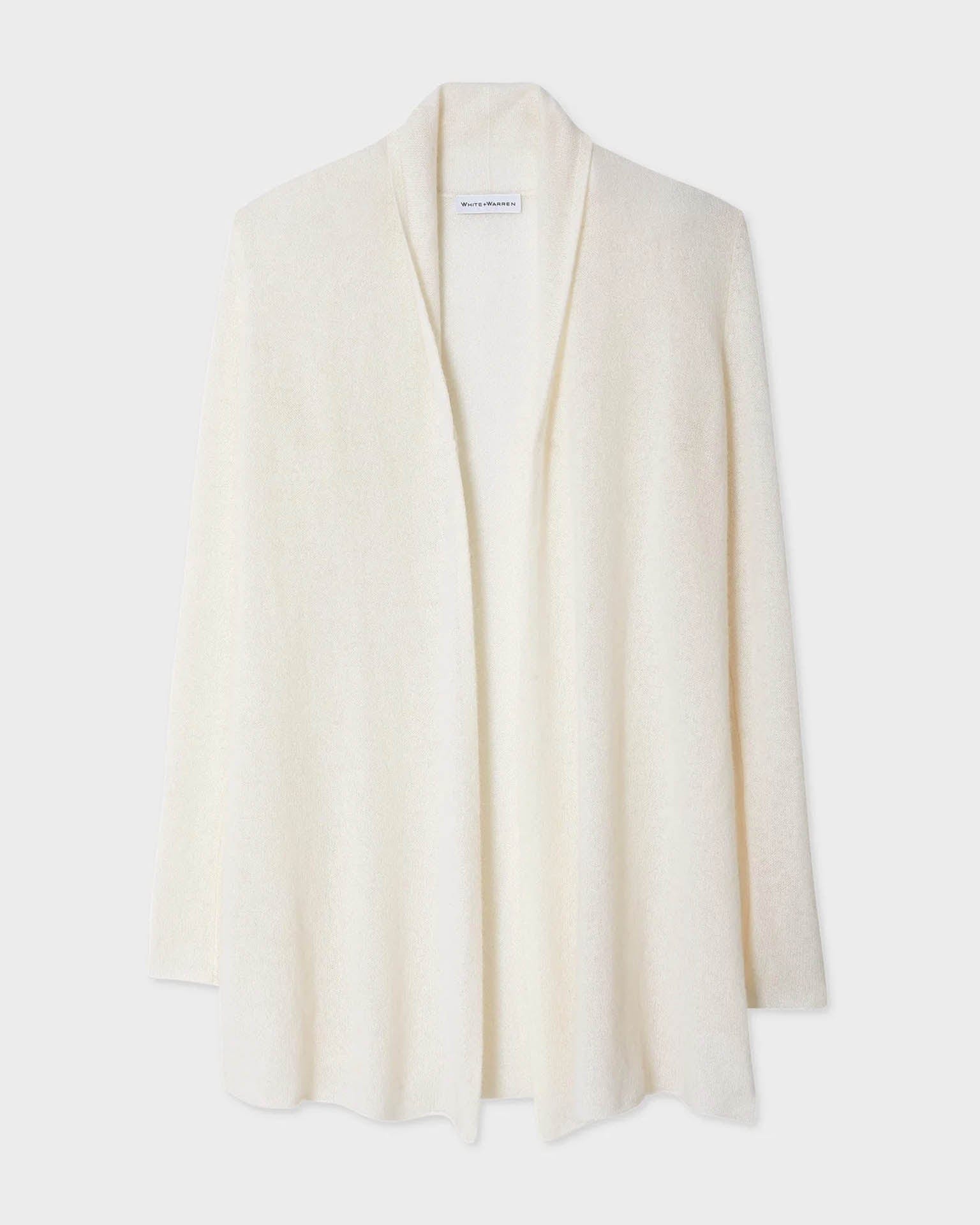 The Cashmere Trapeze Cardigan in Soft White by White & Warren features an open front, long sleeves, and a relaxed drape, shown against a plain white background.