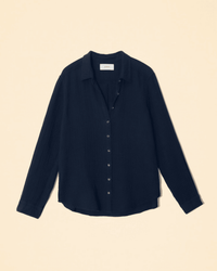 The XiRENA Scout Shirt in North Star is a women's long sleeve cotton gauze shirt with a button-up front and collar, shown flat on a beige background.