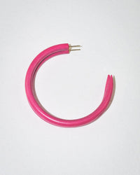 The B&L C Hoop in Large, Knock Out Rose—a single pink hoop earring with a broken clasp and made from sustainably sourced materials—is displayed on a plain white background.