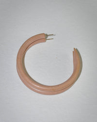 The B&L Large Hoop in Petal is a bold, light pink mango wood earring with a matte finish, shown open on a white background to reveal its 14k gold filled posts and clasp.