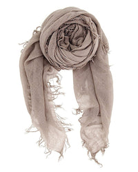 The Chan Luu Cashmere & Silk Scarf in Cinder features a light brown, loosely woven design with frayed edges and fringe, rolled in a spiral with two ends hanging down.