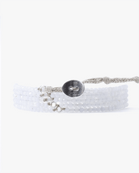 The Chan Luu CL Blue Lace Agate & SS Wrap Bracelet features blue lace agate beads, sterling silver accents, and a braided closure with an engraved silver button. Shown on a white background.