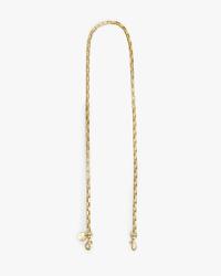 The Box Chain Crossbody Strap in Brass by Clare V. features rectangular links, Italian brass construction, dual end clasps, and a signature charm, shown on a white background.