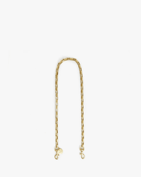 The Clare V. Box Chain Shoulder Strap in Brass, made with Italian brass rectangular links and dual clasps, is shown in a loose arch on a plain white background.