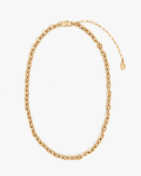 The Clare V. Charm Chain Necklace in Vintage Gold features 14k gold-plated open oval links, a lobster clasp, and an adjustable extender with a small oval tag, styled in a loose oval on a plain white background.