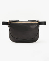 The Clare V. Fanny Pack in Black Vlvt Leather features a gold zipper, minimalist design, smooth texture, and adjustable belt, shown against a plain white background.