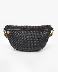 The Clare V. Grande Fanny in Black Woven Zig-Zag features a gold zipper, gold hardware on the strap attachments, and an adjustable belt, shown against a plain white background.
