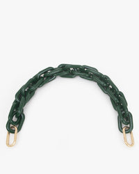 The Clare V. Shortie Strap in Fern Acrylic features chunky dark green resin links and gold clasps at both ends, shown curved on a plain white background. Perfect as a removable strap for Clare V. bags.