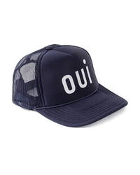 The Clare V. Trucker Hat - Oui - Navy w/ White features a curved brim, breathable mesh back, large white "OUI" on the front panel, and an adjustable snapback closure for a comfortable fit.