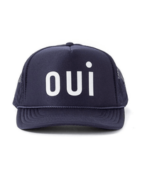 The Clare V. Trucker Hat - Oui - Navy w/ White features a flat bill, bold white “oui” on the front, and a classic snapback closure for adjustable fit.