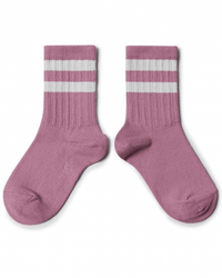 A pair of Collegien Nico Varsity Socks in Rose Bonbon, made in France with two white stripes at the top, displayed side by side on a white background. These super soft socks add sporty charm and comfort to any outfit.
