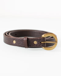 The Depalma Handsewn CL 3/4 inch Belt in Smoke/Brass features dark brown genuine leather, a rounded brass buckle, two brass rivets, and a matching leather loop, shown coiled on a white background.