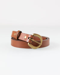 The Depalma Handsewn CL 3/4 inch Belt in Tobacco/Brass, a slim brown leather belt with a brass buckle, is coiled neatly on a white background.