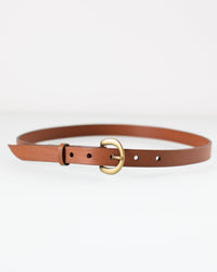The Depalma Handsewn CL 3/4 inch Belt in Tobacco/Brass, featuring genuine leather and a brass oval buckle, is displayed in a circular shape on a white background.
