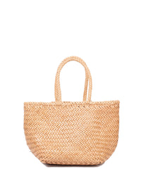 The Dragon Diffusion Grace Basket - Small in Natural is a woven straw tote with two handles, featuring a light tan hue and simple textured design. It's shown against a plain white background.