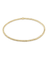A gold beaded necklace with small, evenly spaced round beads pairs perfectly with the enewton Classic Gold 2mm Bead Bracelet, creating a timeless and elegant look.