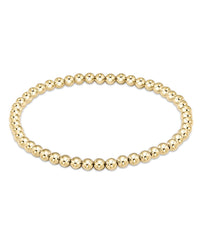 The enewton Classic Gold 4mm Bead Bracelet features evenly sized, round, shiny 14k gold-filled beads arranged in a circle and is pictured on a plain white background.
