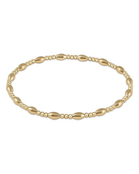 The enewton Harmony Sincerity Pattern 2mm Bead Bracelet in gold features alternating small round and oval beads, creating an elegant and continuous design inspired by the brand’s signature style.