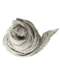 The Grisal Love Cashmere Scarf in Heather Grey X Milk features a light grey textured finish with frayed edges, shown rolled in a spiral on a white background.