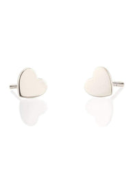 A pair of Kris Nations Heart Studs in Silver rest on a white background, each elegant earring forming a delicate silver heart with a subtle reflection beneath.