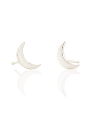 Moon Studs in Silver by Kris Nations, a pair of small sterling silver earrings, are elegantly displayed against a white background.