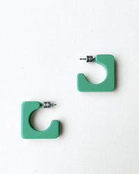 The Machete Atlas Hoops in Bright Green are chunky, square-shaped earrings made from Italian acetate with silver posts—stylish and hypoallergenic, shown on a plain white background.