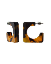 The Atlas Hoops in Tortoise by Machete are square earrings made from Italian acetate with a striking tortoiseshell pattern. Set against a white background, they feature secure post back closures and showcase Machete's dedication to style and craftsmanship.