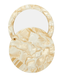 The Machete Circle Mirror in Ivory is a round Italian acetate purse mirror featuring a glossy, pearlescent beige marbled finish with an open lid that reveals the mirror inside.