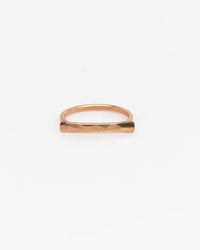 The Nashelle Faceted Bar Ring in Gold features a slim, minimalist design with a hammered finish—perfect for stacking and shown against a white background.