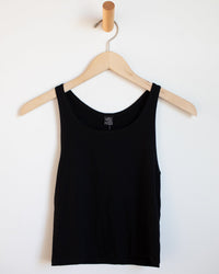 The SF Muscle T in Black by Only Hearts is displayed on a wooden hanger against a white wall.
