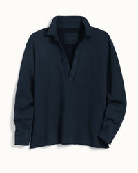 The Patrick Henley in British Royal Navy Terry by Frank & Eileen features long sleeves, a relaxed fit, open collar with no buttons, an unfinished hem, and a casual, slightly wrinkled look.