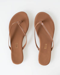 The Tkees Glosses Flip Flop in Beach Bum features slim brown straps and a minimalist design—perfect sandals for sunny days, styled side by side on a white background.
