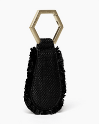 The Fray in Black & Gold by TopTote is a black woven keychain with a fringed edge and gold hexagonal ring, designed as a stylish travel hat accessory. It stands upright against a plain white background.