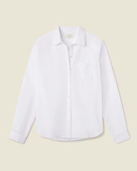 The Grace Classic Shirt in White by Trovata Birds of Paradis, a long sleeve cotton shirt with a chest pocket, is laid flat on a light beige background.