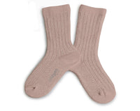 A pair of Collegien Victorie Extra Soft Glittery Socks in Vieux Rose, light pink with a subtle shimmer, are laid flat and crossed at the ankles on a white background.