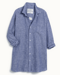 The Mackenzie in Famous Blue by Frank & Eileen is a light blue, long-sleeve Italian linen shirt with a button-down front, rolled sleeves, oversized fit, collar, chest pocket, and a visible inner collar tag.