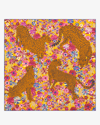 Four orange cheetahs with black spots pose gracefully against a vibrant floral background, inspired by Inoui Editions and reminiscent of the colorful Square 130 Pampa in Fuchsia scarf.