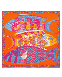 The Inoui Editions Square 130 Tango in Red features three overlapping fish in bold pink, yellow, blue, and orange on an orange background with intricate abstract patterns, bordered like an oversized bandana.