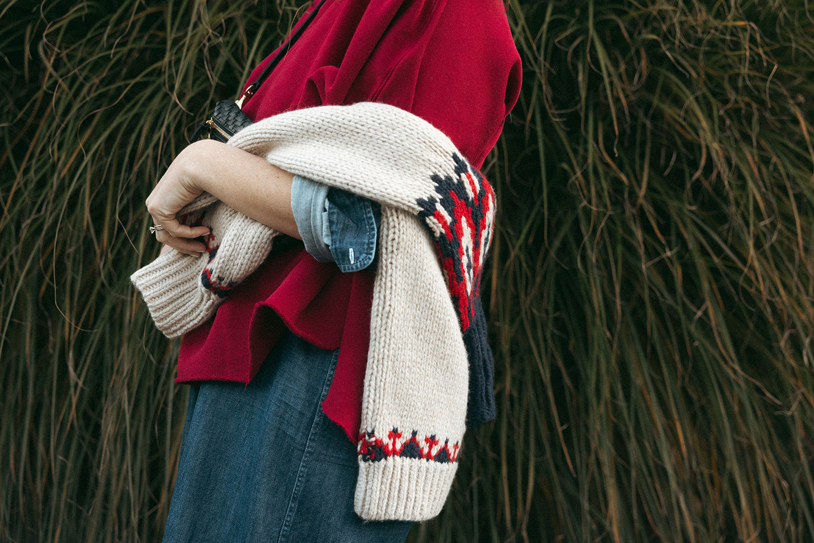 Green and white checkered jacket draped over a bench next to a menu sign displaying prices and items.